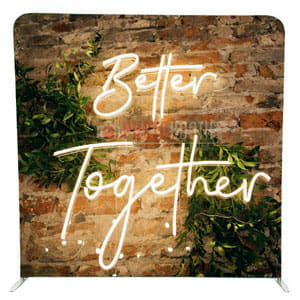 Better Together neon sign on a green foliage photobooth backdrop
