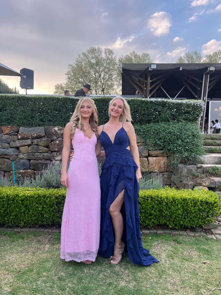 A raw phone photo of two guests at a KZN event, before PhotoPrint LAB's instant AI enhancement