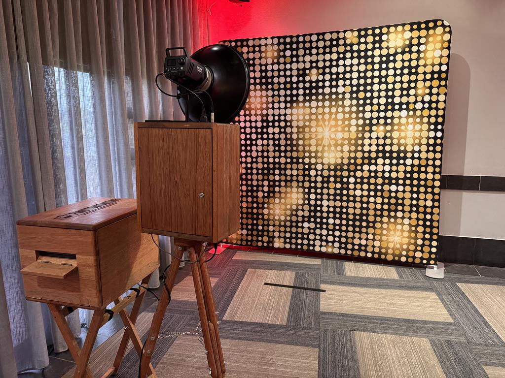 The retro photobooth set up beside a gold sequin backdrop at a KZN event