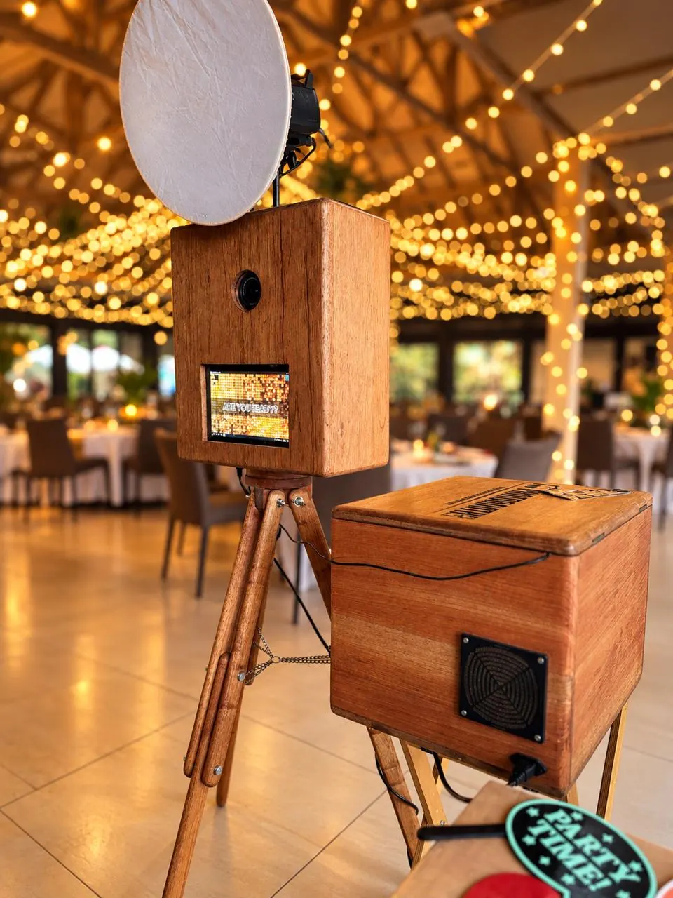 Handcrafted wooden retro photobooth and print box under a ceiling of fairy lights in a KZN Midlands reception hall