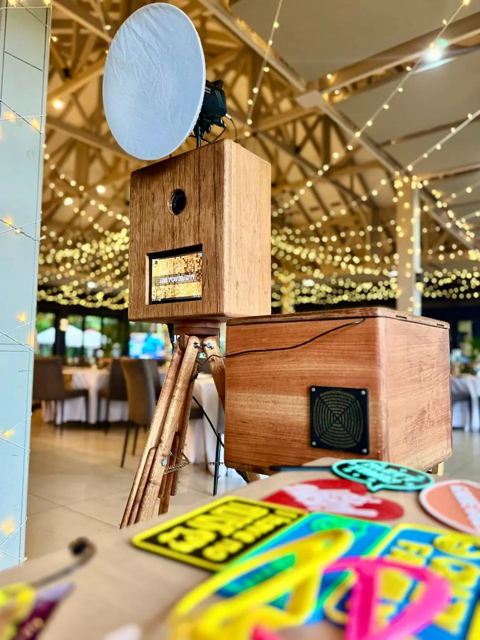 The retro wooden photobooth and props table under fairy lights at a KZN Midlands wedding venue
