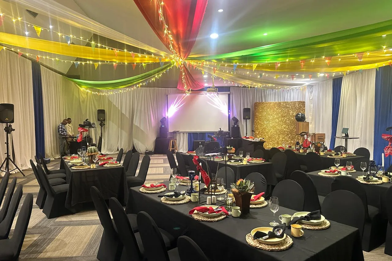 The banquet room at Alpine Heath Resort set for dinner with a gold sequin backdrop at the far end