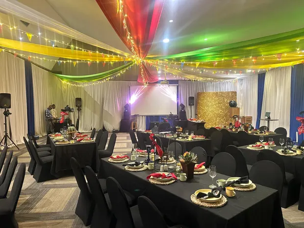 The banquet room at Alpine Heath set for dinner with the gold sequin backdrop at the far end