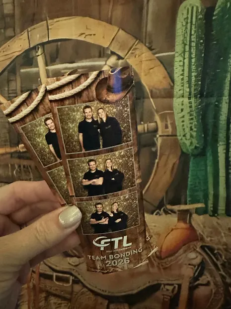 A branded corporate photostrip held up at a team-building event at Alpine Heath