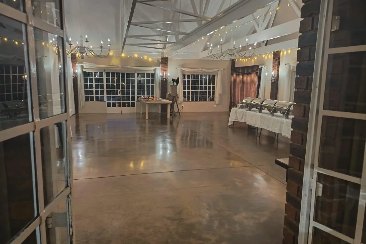 The reception hall at Bellwood, with its open roof trusses and doors open to the dam