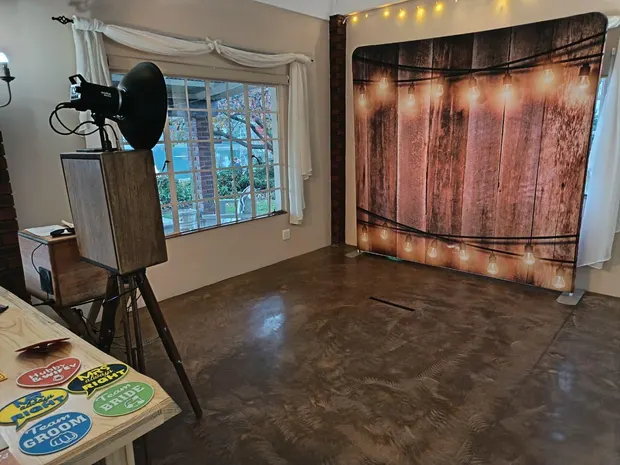 The photobooth and backdrop set up beside the window looking onto the garden at Bellwood