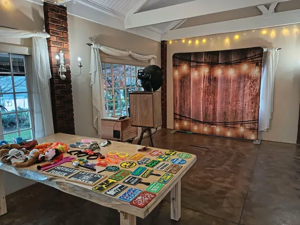 The props table and lit timber backdrop set up in the reception hall at Bellwood