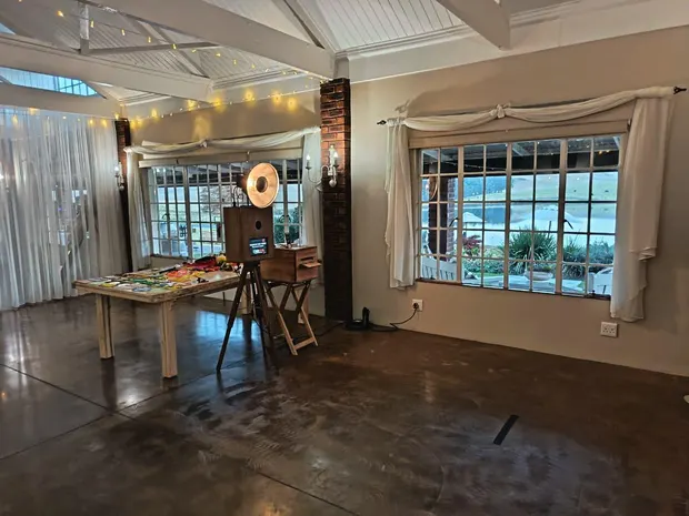 The photobooth and props table at Bellwood, with the dam visible through the windows behind