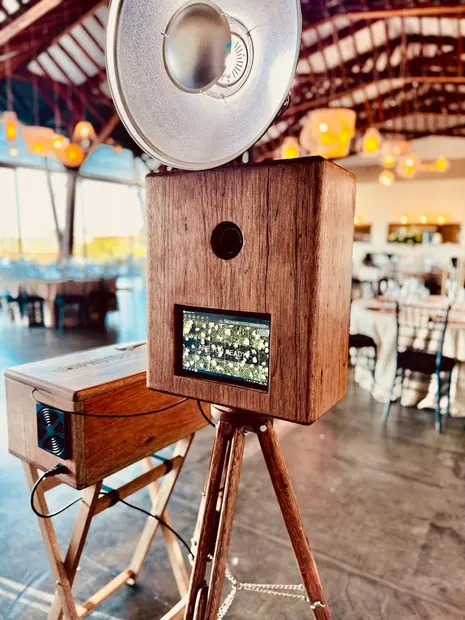 The photobooth under the timber roof at Brahman Hills with tables set for dinner