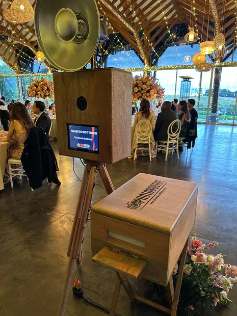 The photobooth at a Brahman Hills wedding reception with guests seated behind
