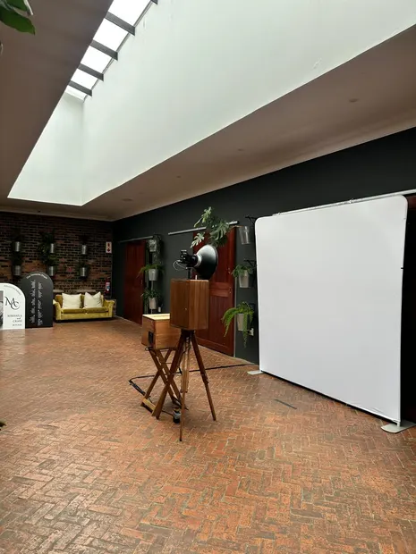 The photobooth and a white backdrop under the skylight in the lounge at Brahman Hills