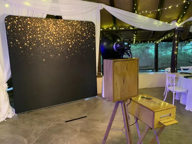 The photobooth and gold-sparkle backdrop under the draped roof and fairy lights at Collisheen