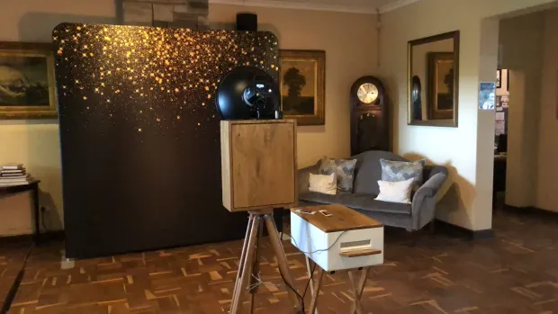 The retro photobooth and a gold-sparkle backdrop in the lounge at Collisheen Estate