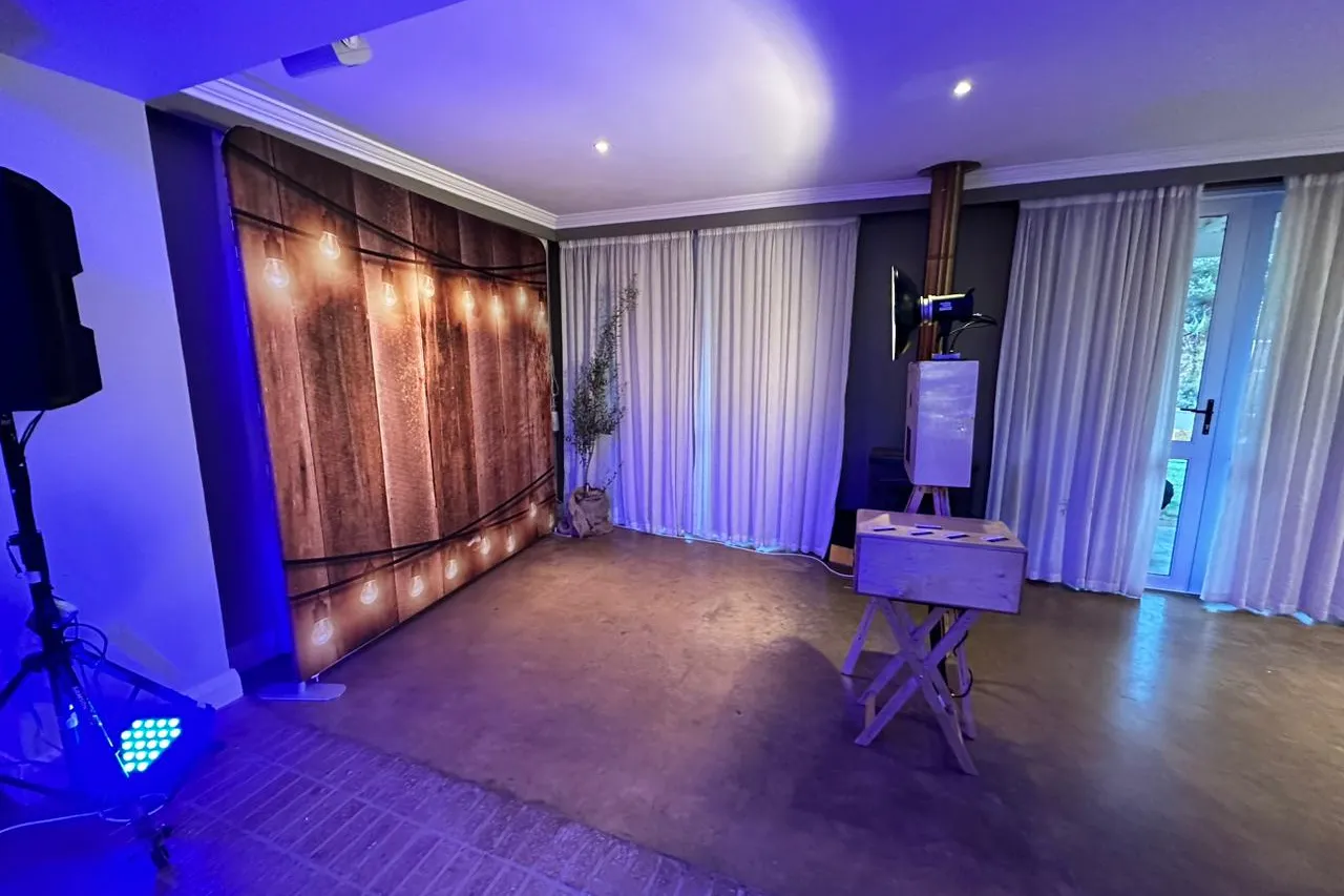 The lit timber backdrop and photobooth in the reception room at Fordoun, Nottingham Road