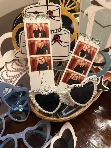 Photostrips propped up among the heart-shaped props at a Granny Mouse wedding