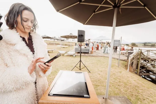 A guest at the instant printing kiosk during canap&eacute;s at Haycroft Farm