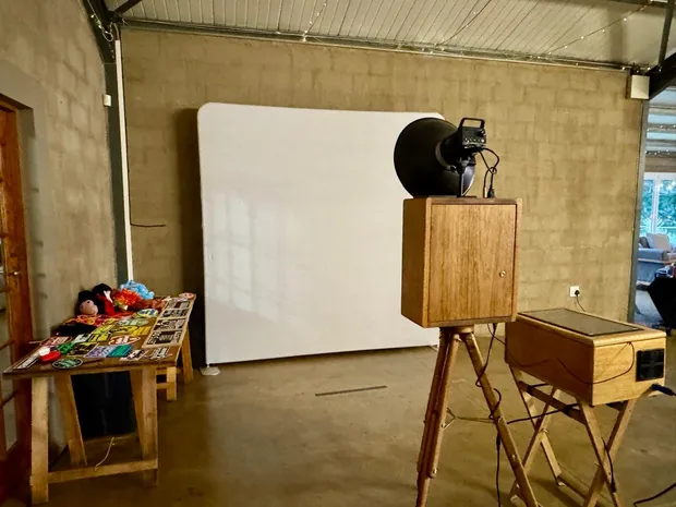 The retro photobooth and props table against a white backdrop at Haycroft Farm