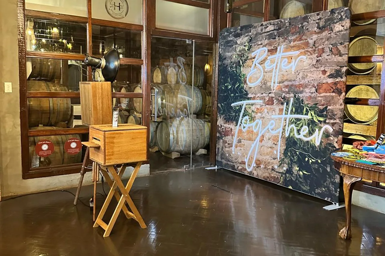 The retro photobooth beside a Better Together backdrop in the barrel room at Highgate Wine Estate