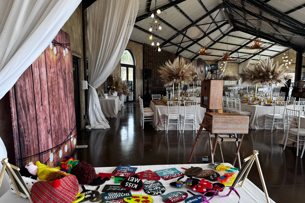 The photobooth, props table and set tables in the reception venue at Netherwood Farm, Nottingham Road