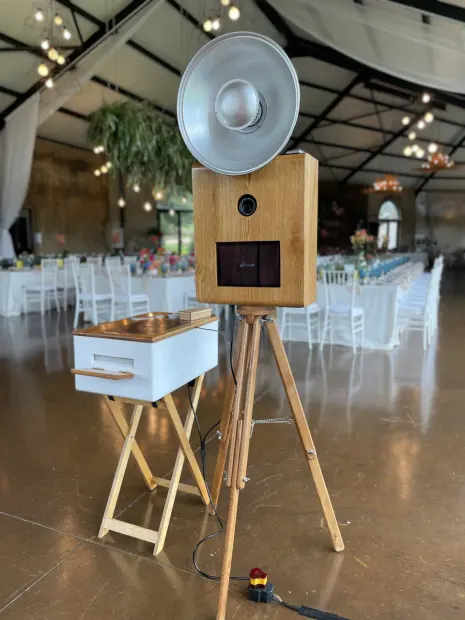 The photobooth in the reception at Netherwood Farm under the hanging greenery