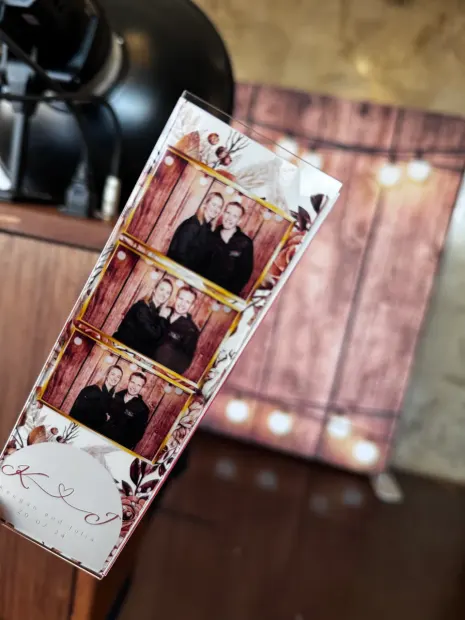 A photostrip held up against the lit timber backdrop at Netherwood Farm