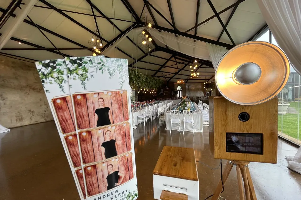 The retro photobooth and a display of prints beside the set tables at Netherwood Farm, Nottingham Road