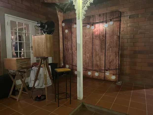 The lit timber backdrop and photobooth beside the French doors at Providence