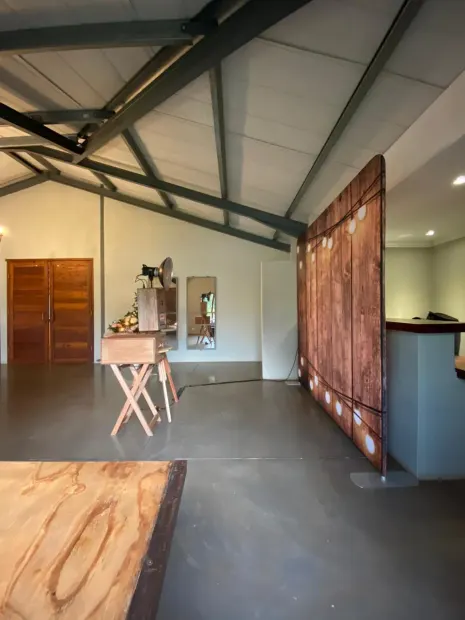 The photobooth and a lit timber backdrop in the hall at Sweet Home, Eston
