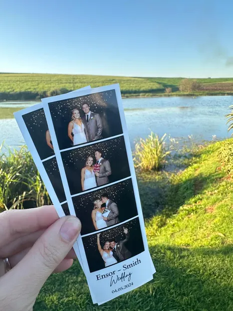 A printed photostrip held up over the dam at Sweet Home, Eston