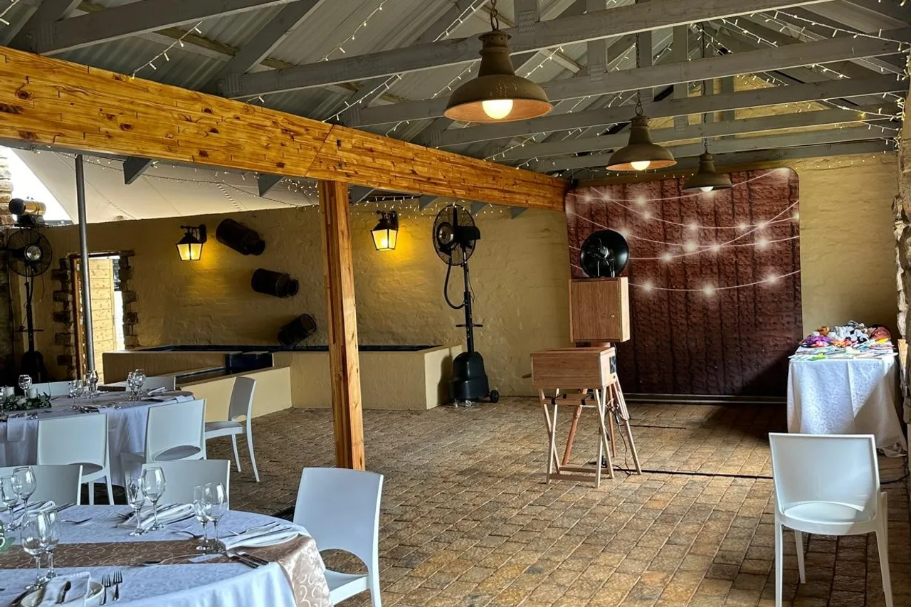 The reception hall set for dinner beneath the timber beam and fairy lights at The Gallery, Nottingham Road