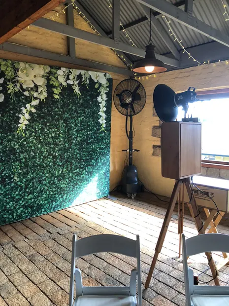 The photobooth against a greenery wall in the breezeway at The Gallery