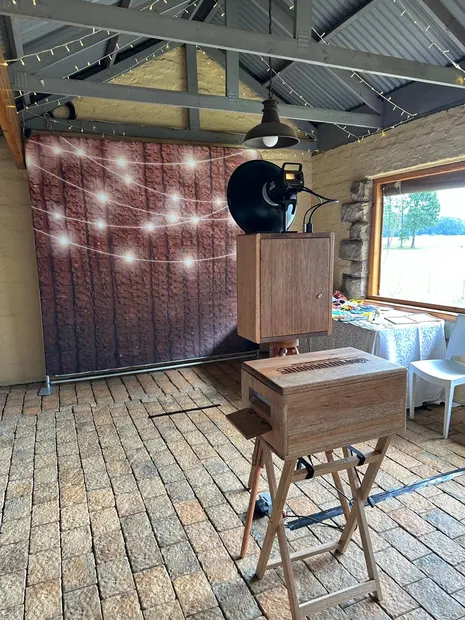 The retro photobooth against a lit backdrop in the sandstone hall at The Gallery, Nottingham Road