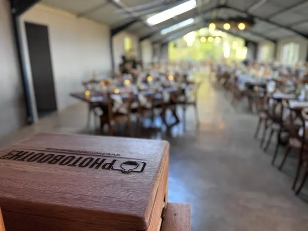 The barn at The Glades set for dinner with the photobooth print crate in the foreground