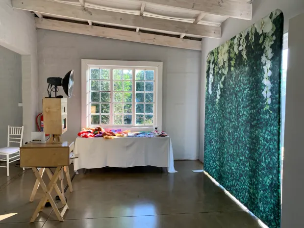 The retro photobooth and a foliage flower wall in the hall at The Groves