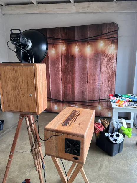 The photobooth and props table against the lit timber backdrop at The Groves