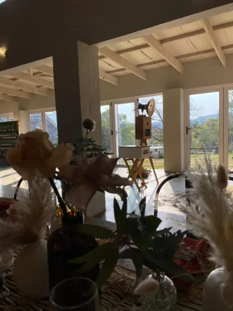 The photobooth behind a reception table of dried florals at The Groves