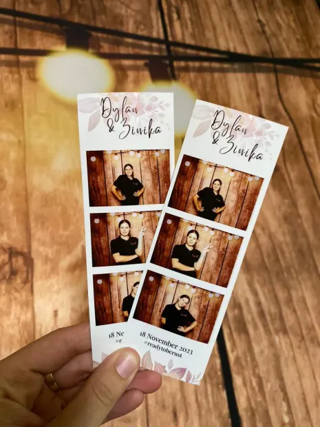 Two printed photostrips from a wedding at The Groves held against a timber backdrop